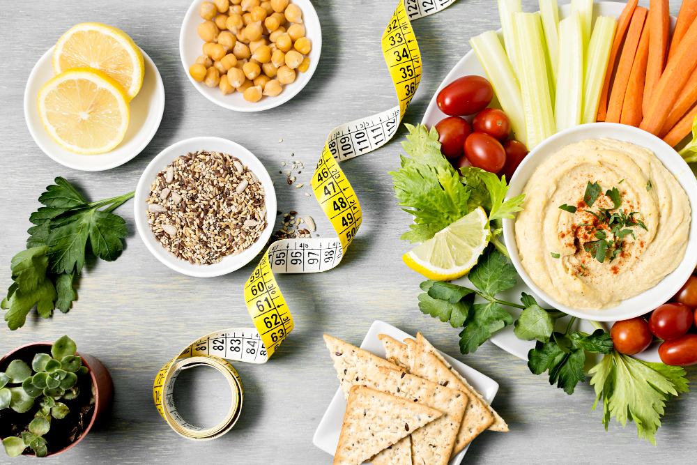 top-view-of-hummus-with-assortment-of-vegetables-and-measuring-tape.jpg